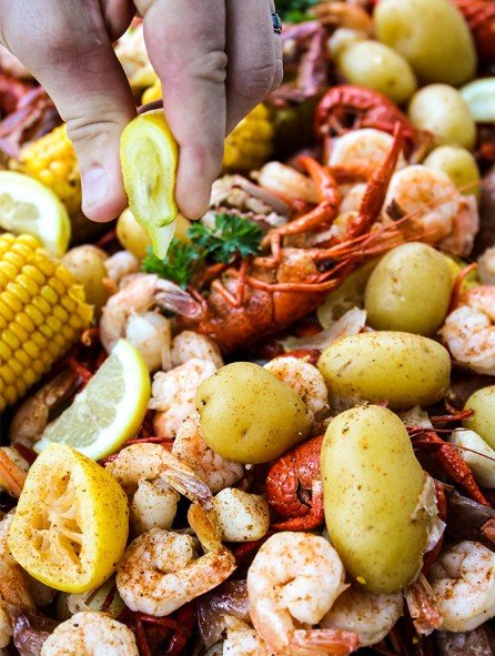 Seafood boil including shrimp, potatoes, corn, crawfish and lemon